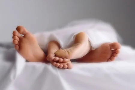 Couple-in-bed-close-up-of-feet-entwined.jpg Couple-in-bed-close-up-of-feet-entwined.jpg