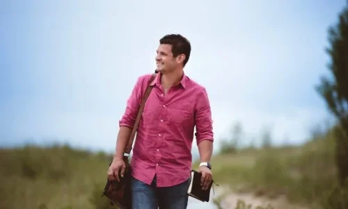 man-walking-with-book-550x330.jpg