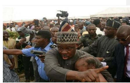 Image result for IN PICTURES: Gov Amosun fights mob at Adeleke's burial, saves female politician from lynching